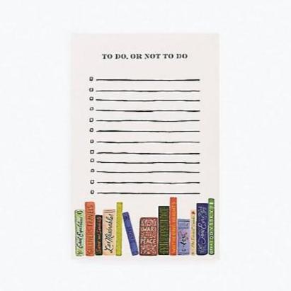 notepad with stack of books on the bottom