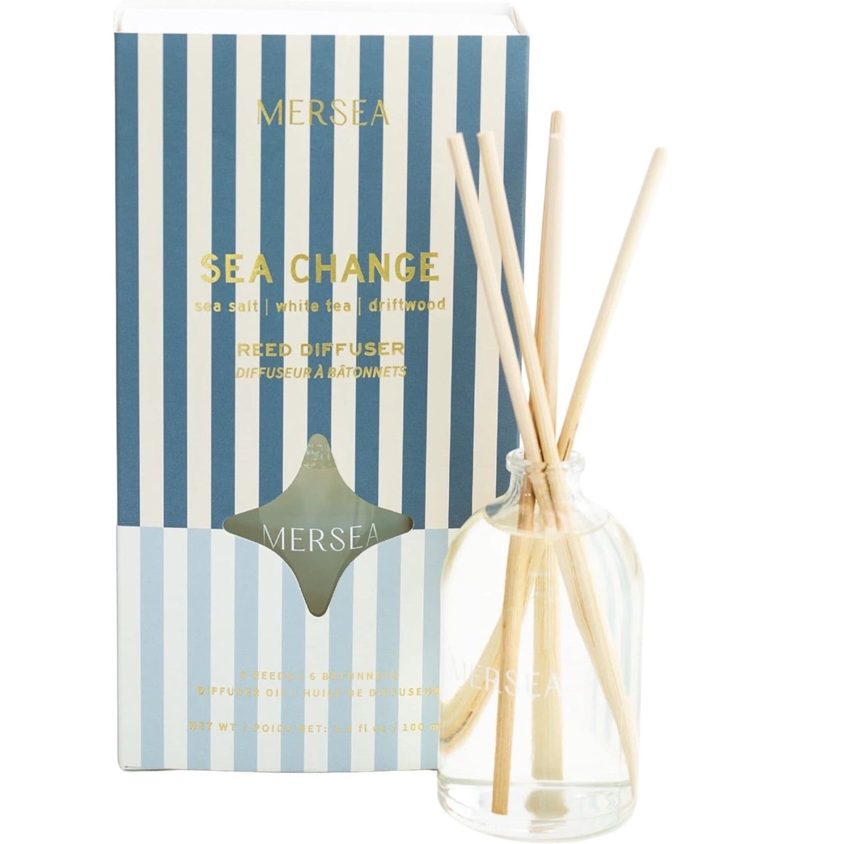 blue vertically striped box with gold text. reed diffuser in front of it