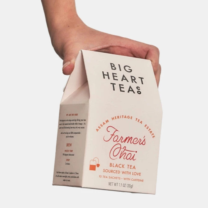 hand holding cream tea box with orange writing