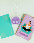 timer with purple sand and relaxation cards next to it