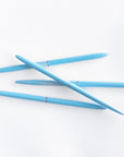 Four BLUE BULLET PENS on white background.