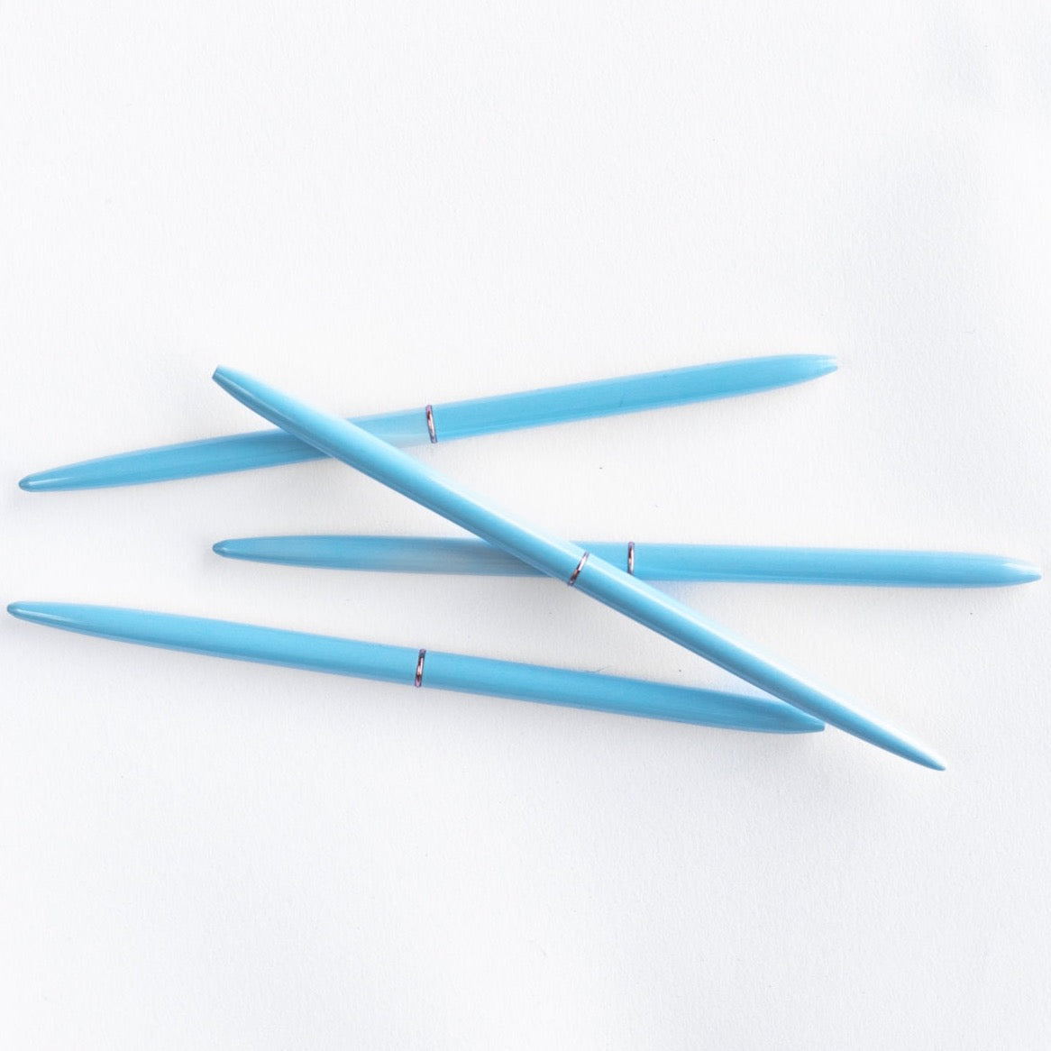 Four BLUE BULLET PENS on white background.