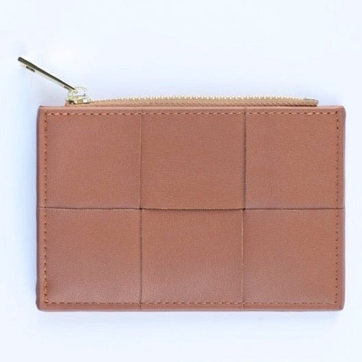 A caramel brown colored woven vegan leather card case wallet with a gold zipper. photographed against a white background.