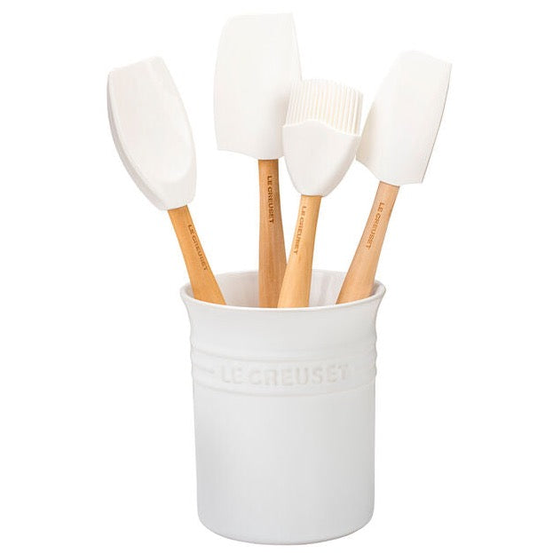 White utensil holder with four cooking utensils inside.