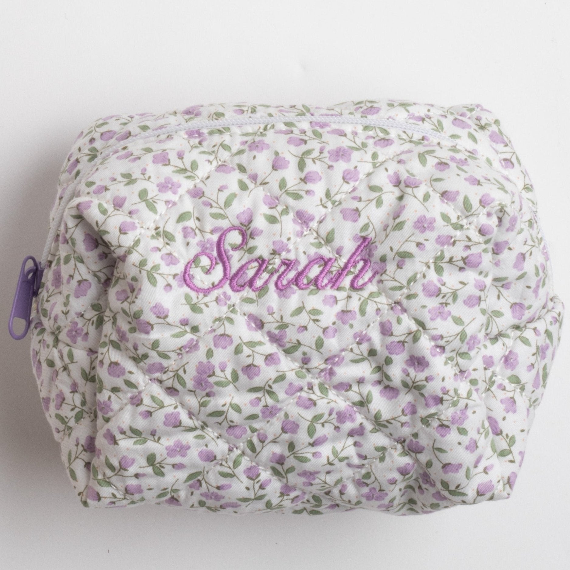 purple floral makeup bag embroidered with the same "Sarah"