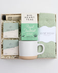 BOXFOX HEAL Gift Box with 2 shower steamers, a travel hand cream, mint & lavender tea, a speckled ceramic mug, and sage cozy socks