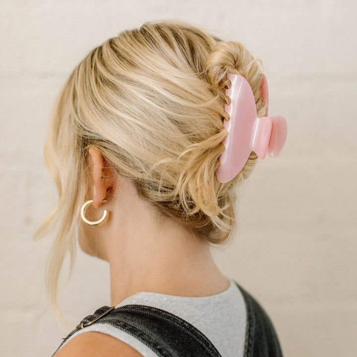 pink hair clip in blonde hair