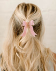 pink bow hair clip in blonde hair