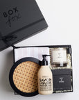 BOXFOX Housewarming Gift Box with a rattan tray, tea towel, hand soap, a candle, and a candle snuffer