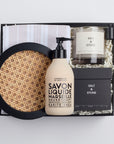 BOXFOX Housewarming Gift Box with a rattan tray, tea towel, hand soap, a candle, and a candle snuffer