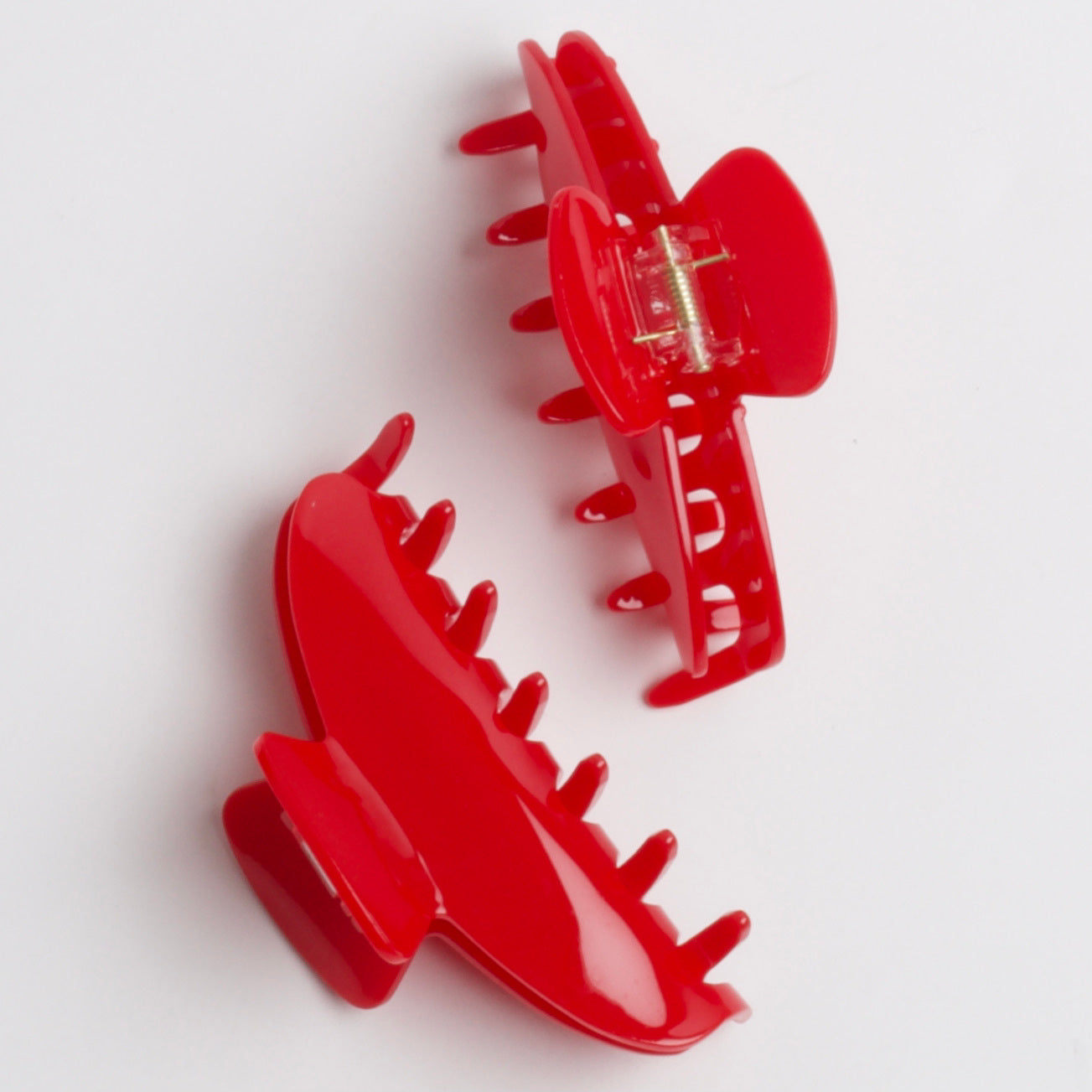 2 bright red claw clips