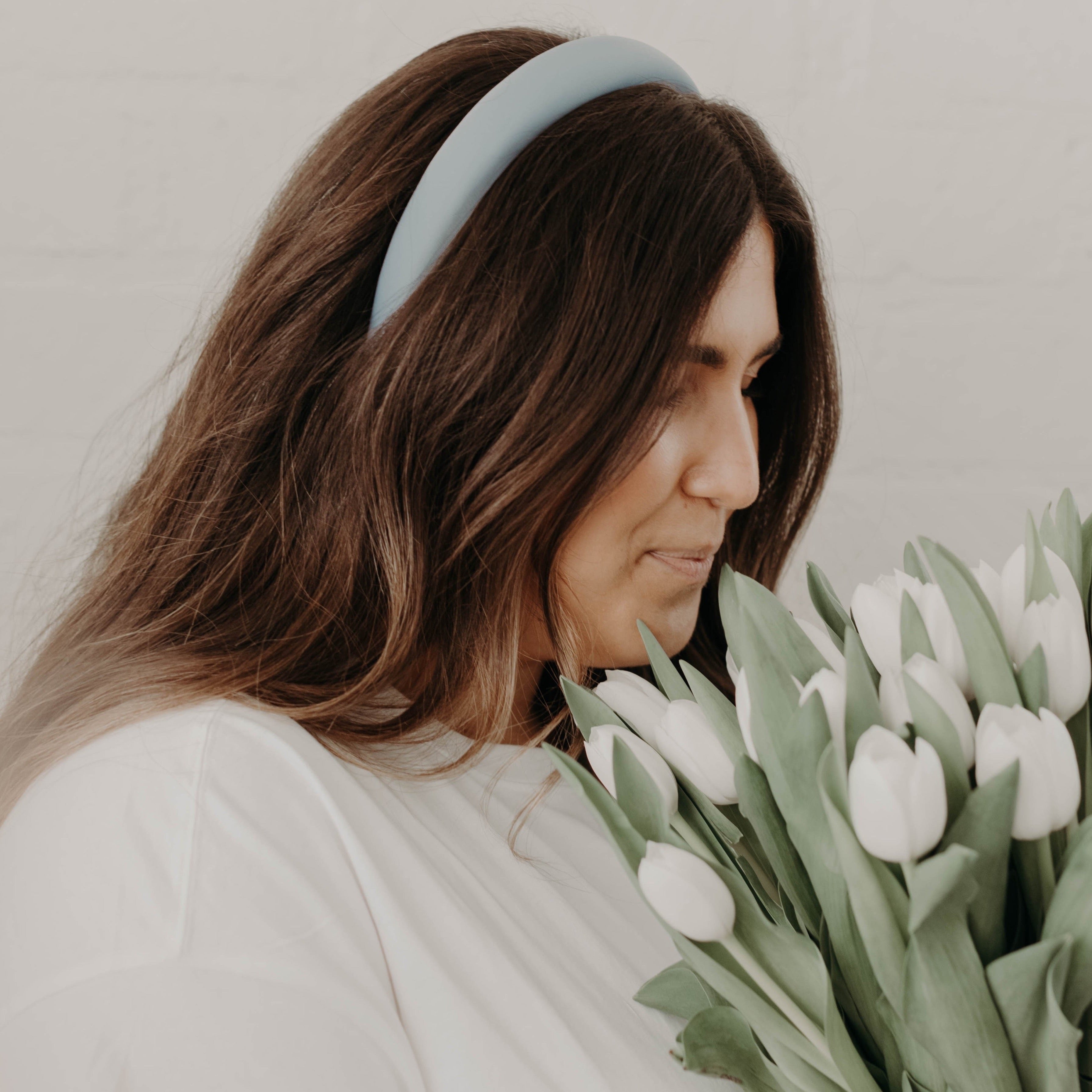 Girl with brunette hair wearing Blue Satin Padded Headband