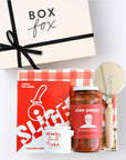 BOXFOX creme gift box packed with "Slice" Pizza book, wood pizza cutter, Ciao Pappy Marinara sauce, Pizza herbs jar and plaid red Geometry tea towel.