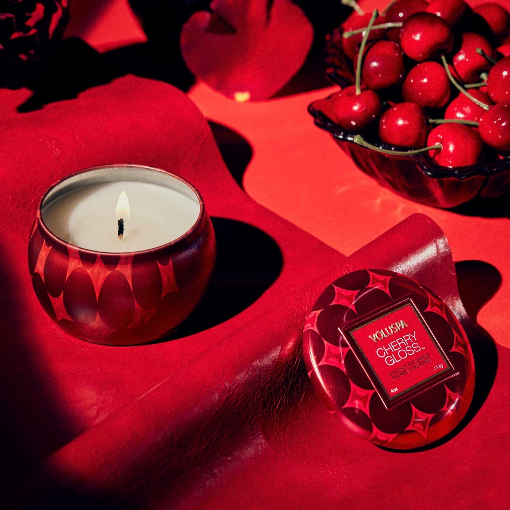 round red tin candle with red background