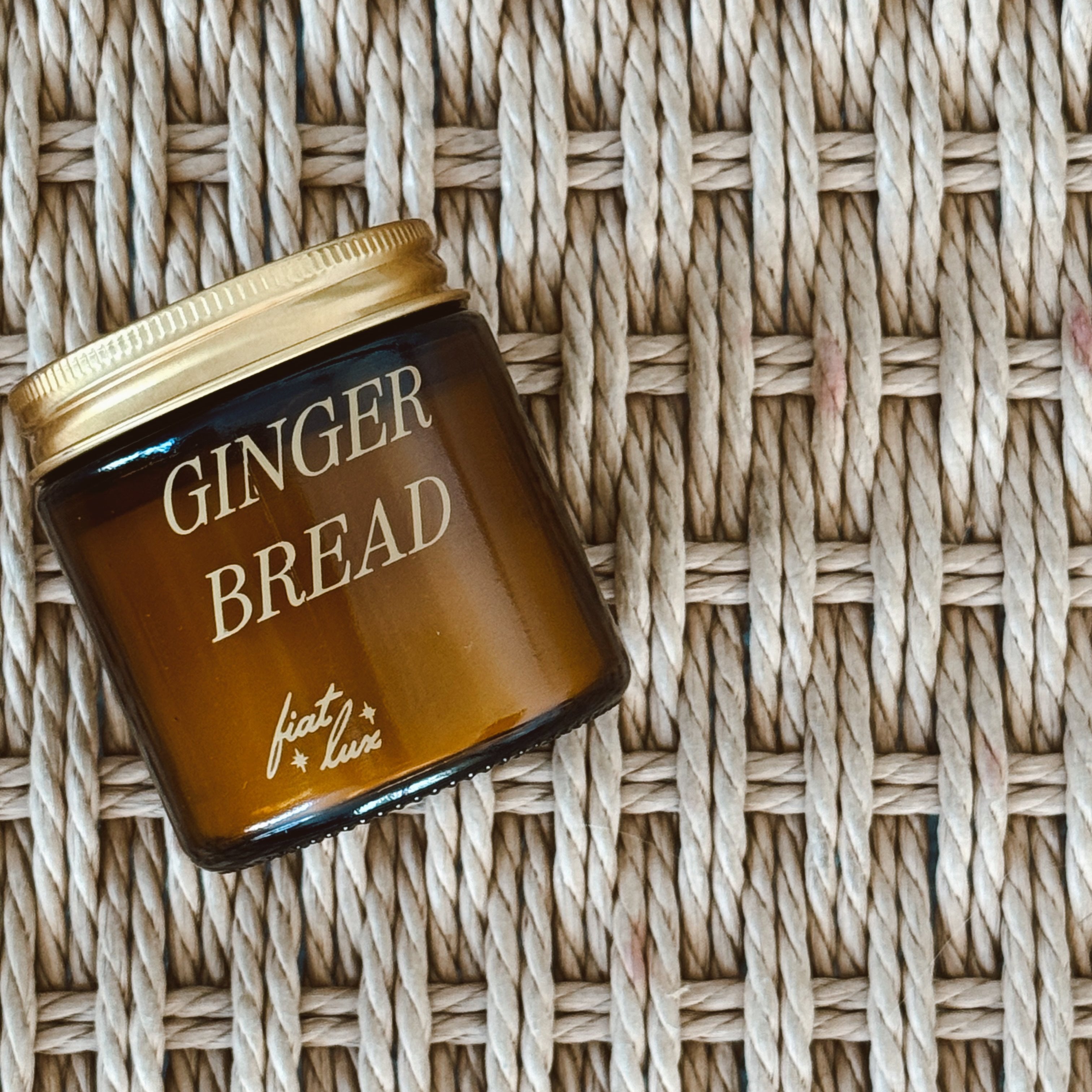 mini amber candle jar with 'GINGERBREAD' printed on it