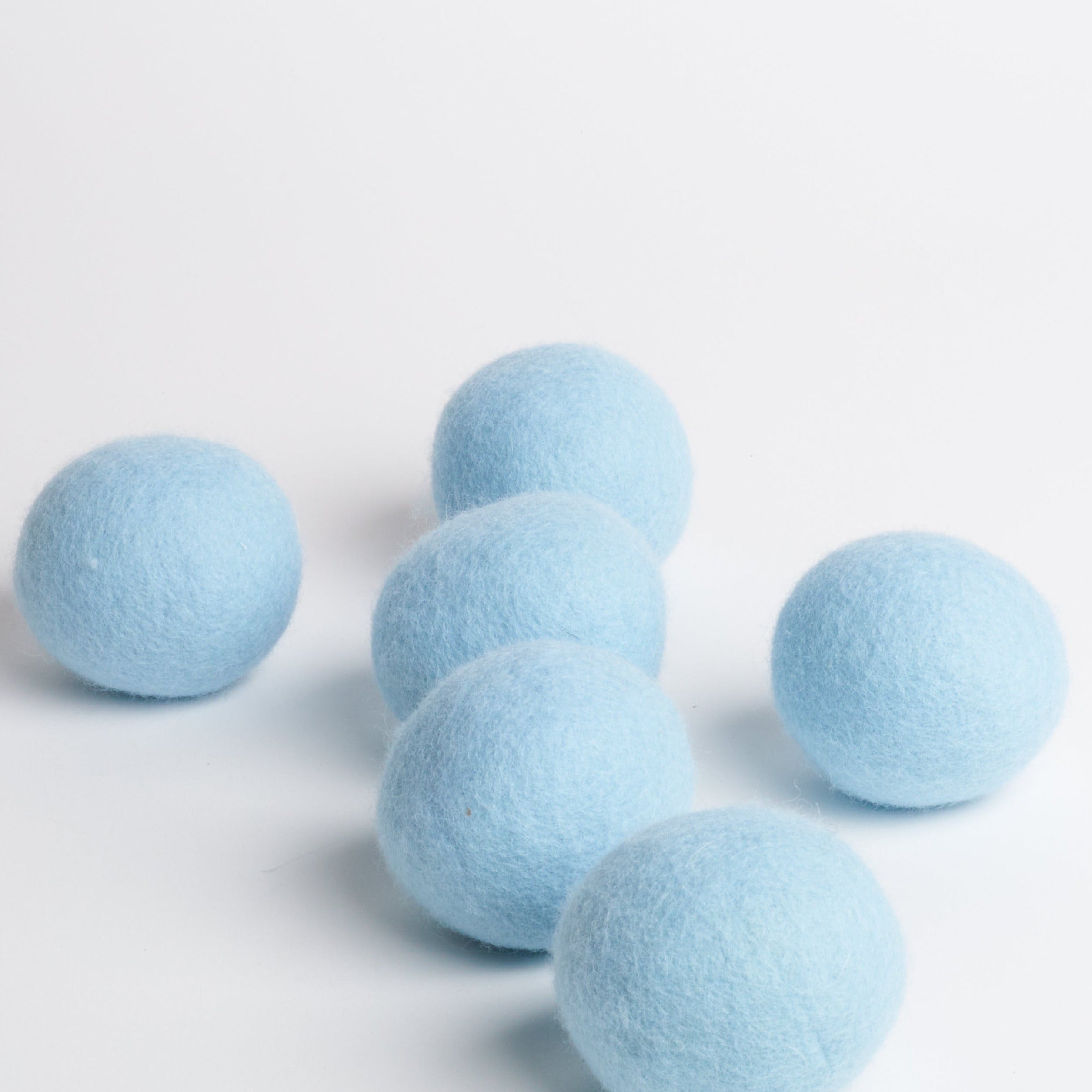 Pack of 6 dryer balls on white background.